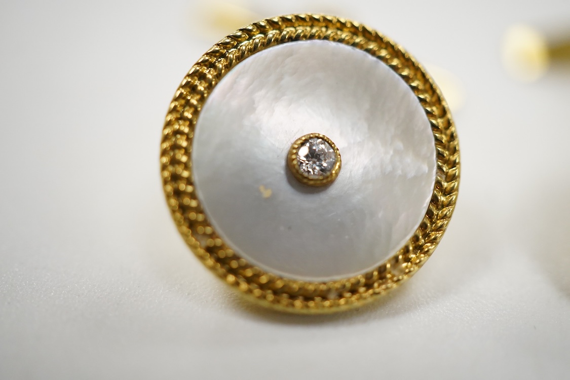 A pair of yellow metal (stamped 18) mounted, mother of pearl and diamond set disc cufflinks, diameter 12mm, gross weight 5.2 grams.
